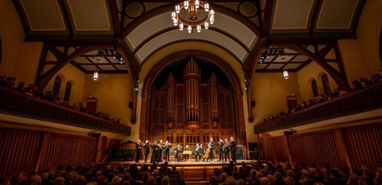 Interior view of Tafelmusik's performance venue and musicians onstage.